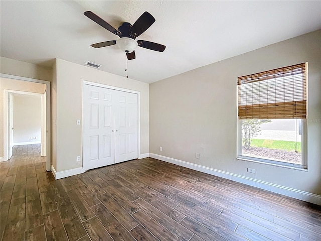 5058 Westlake Blvd, Dade City, FL 33523 - unfurnished bedroom featuring dark wood-type flooring, baseboards, and a closet