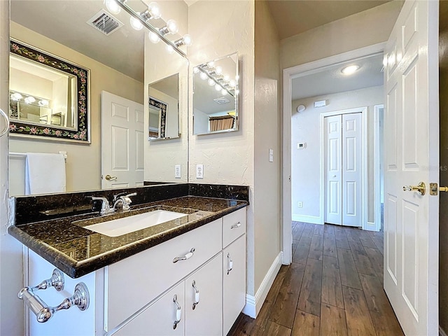 5058 Westlake Blvd, Dade City, FL 33523 - bathroom with wood-type flooring, baseboards, and vanity