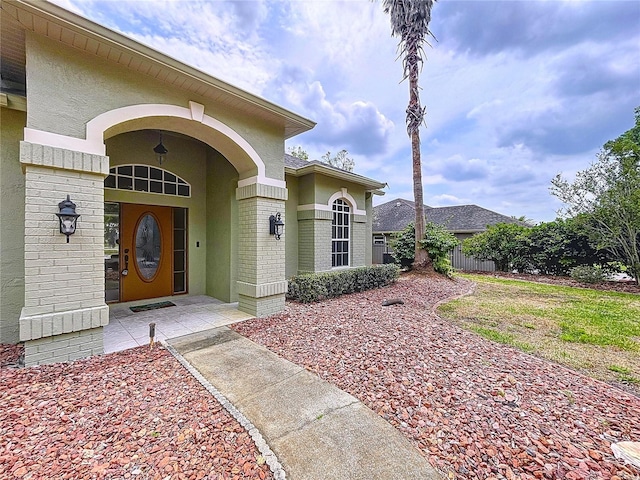 5058 Westlake Blvd, Dade City, FL 33523 - entrance to property featuring stucco siding, brick siding, and fence