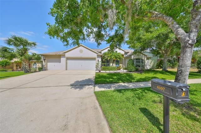 ranch-style house with concrete driveway, stucco siding, a front lawn, and a garage