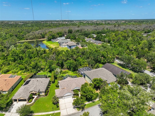 bird's eye view featuring a forest view, a residential view, and a water view