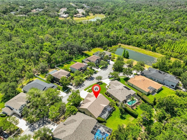 aerial view with a forest view, a residential view, and a water view