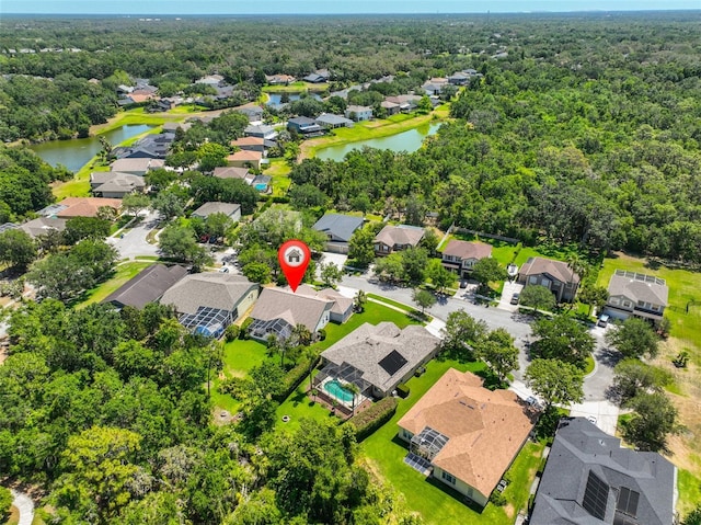 bird's eye view with a residential view, a water view, and a forest view
