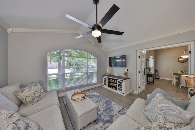 living room featuring ornamental molding, ceiling fan, wood finished floors, and lofted ceiling