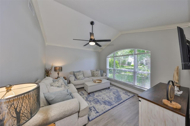 living area with crown molding, visible vents, wood finished floors, lofted ceiling, and ceiling fan