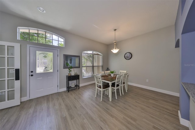 dining room featuring light wood-style floors and baseboards