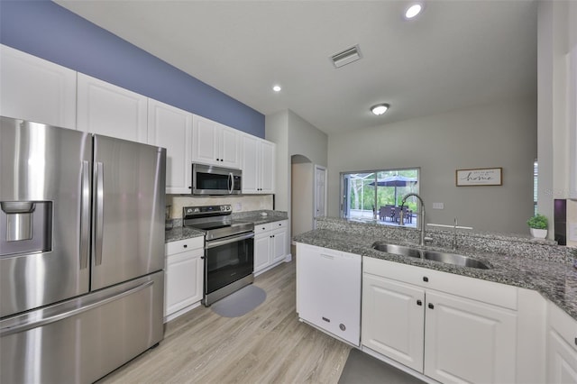 kitchen featuring white cabinets, appliances with stainless steel finishes, a sink, and visible vents