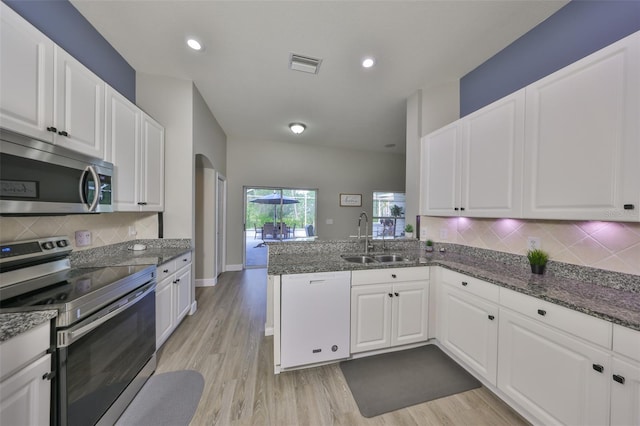 kitchen featuring visible vents, a sink, white cabinetry, and appliances with stainless steel finishes