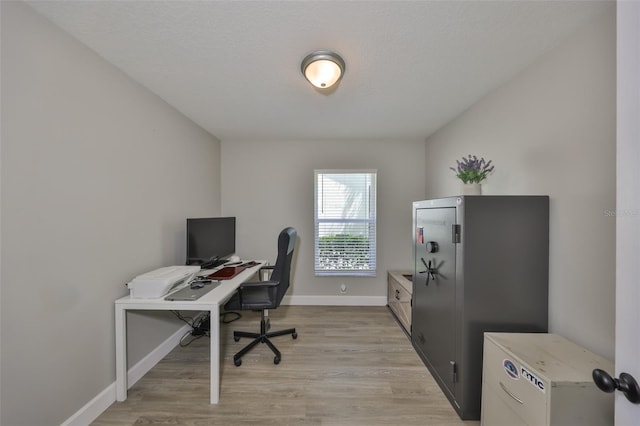 office featuring baseboards and light wood-style flooring
