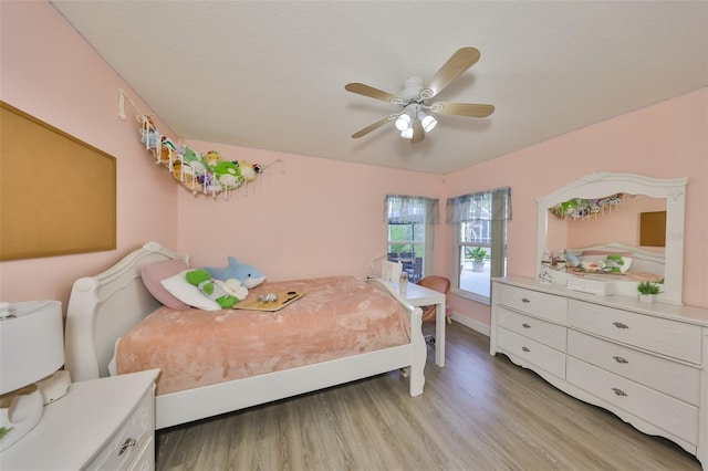 bedroom with light wood-type flooring and ceiling fan