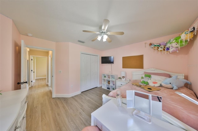 bedroom with visible vents, a closet, baseboards, light wood-type flooring, and a ceiling fan