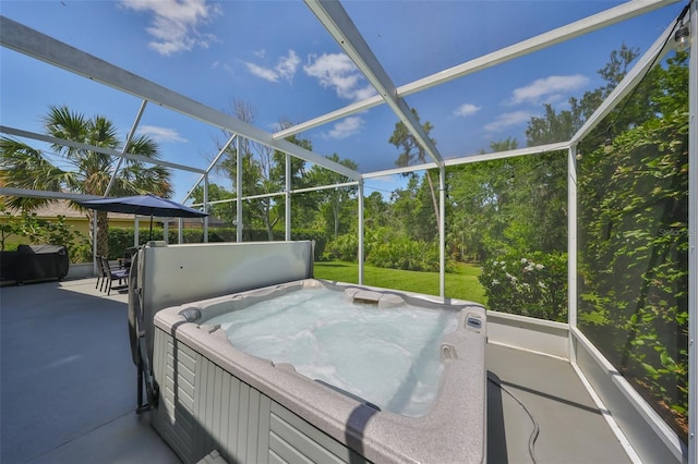 view of patio with a hot tub and a lanai