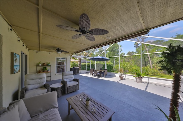 view of patio with an outdoor living space, outdoor dining area, ceiling fan, and a lanai