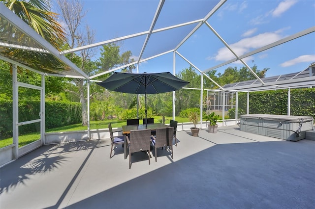 view of patio / terrace featuring glass enclosure, a hot tub, and outdoor dining space