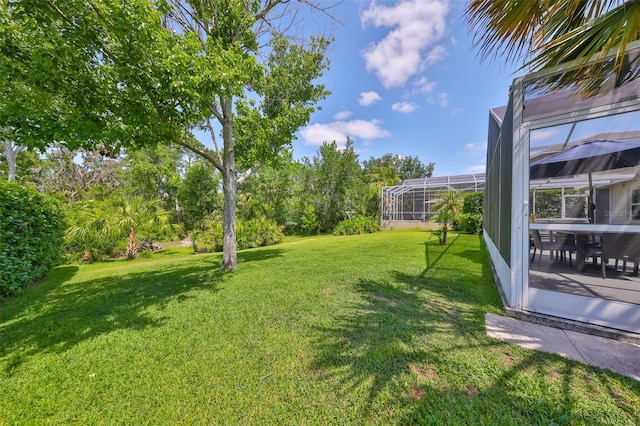 view of yard with glass enclosure