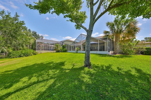 view of yard featuring glass enclosure