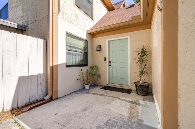 doorway to property with stucco siding