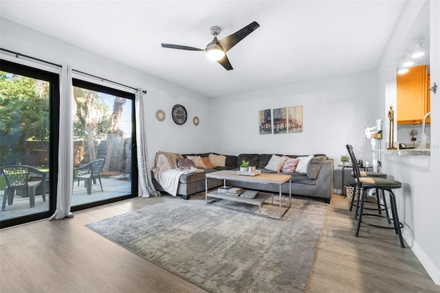 living room featuring ceiling fan and wood finished floors