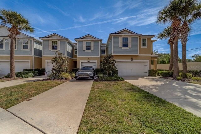 view of front of property with an attached garage, a front lawn, stucco siding, and concrete driveway