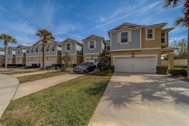view of front of house with a front lawn, stucco siding, an attached garage, driveway, and a residential view