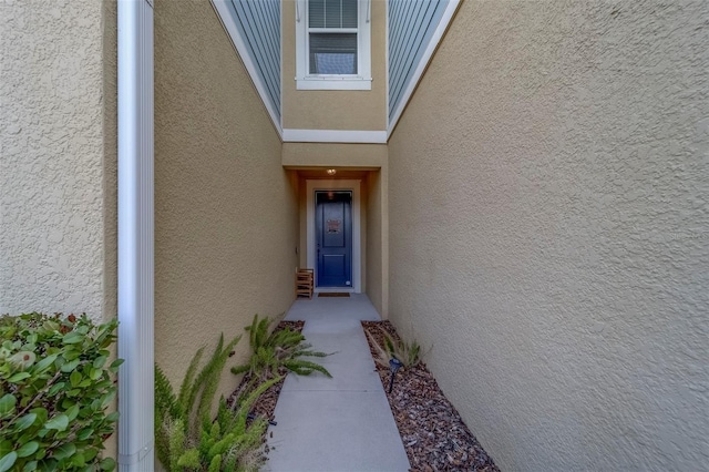 view of exterior entry featuring stucco siding