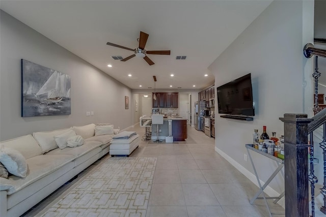 living room featuring ceiling fan, visible vents, light tile patterned floors, baseboards, and recessed lighting
