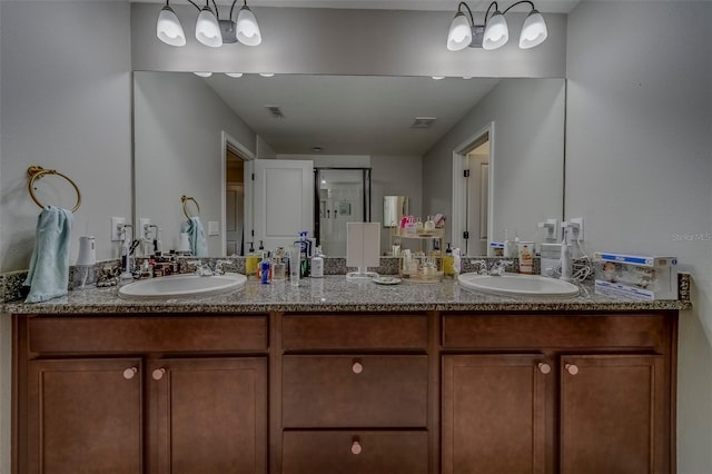 full bathroom featuring double vanity, visible vents, and a sink