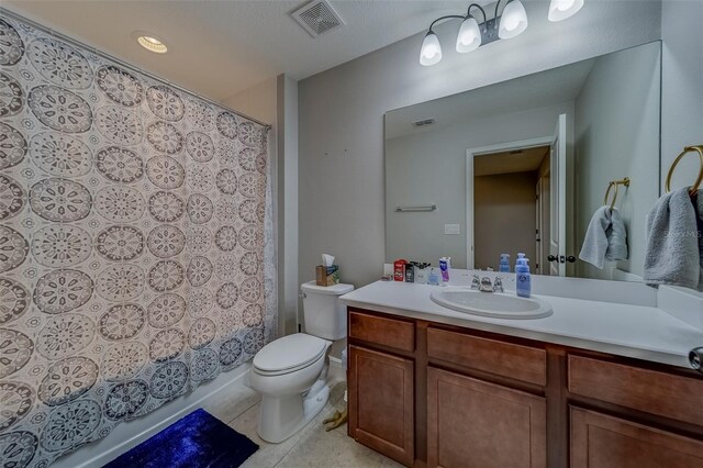 bathroom with vanity, tile patterned floors, toilet, and visible vents