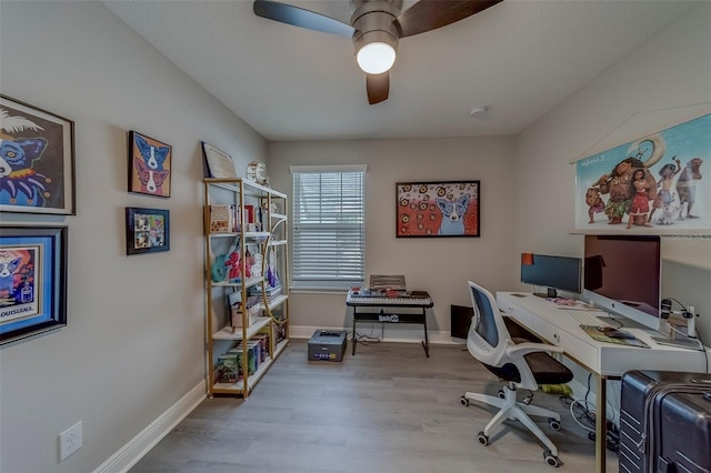 home office with baseboards, ceiling fan, and wood finished floors