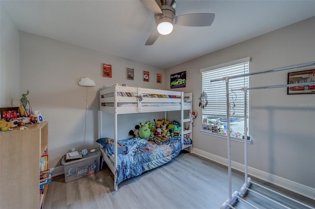 bedroom featuring baseboards, ceiling fan, and wood finished floors
