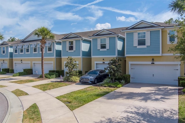 view of front of home featuring an attached garage, stucco siding, and driveway