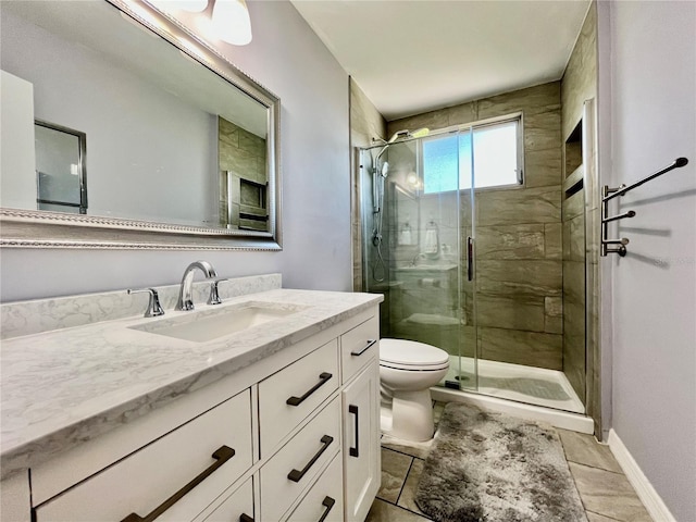 full bathroom with vanity, toilet, baseboards, tile patterned floors, and a stall shower