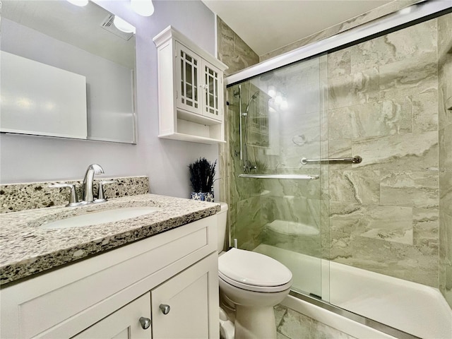 full bath with vanity, a stall shower, toilet, and marble finish floor