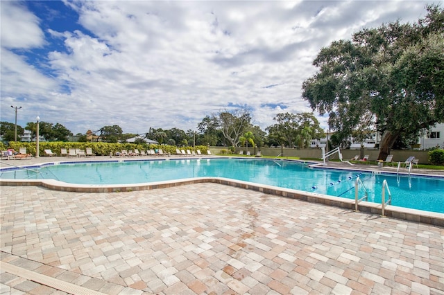 pool featuring a patio and fence