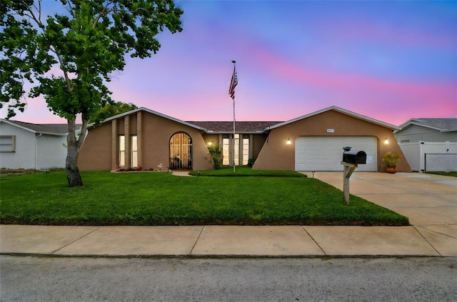 8225 Medford Dr, Port Richey, FL 34668 - view of front of property featuring a garage, driveway, and stucco siding