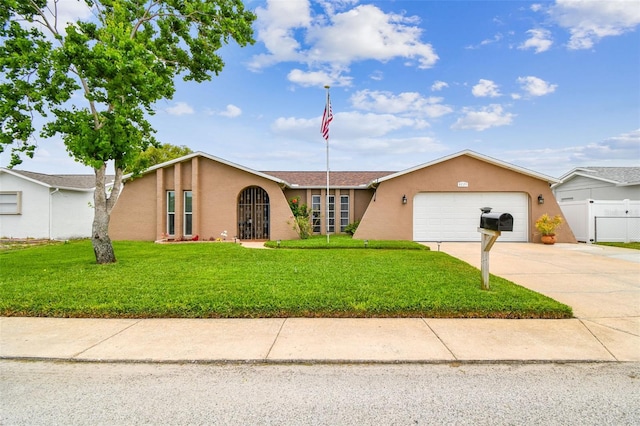 8225 Medford Dr, Port Richey, FL 34668 - view of front of property with stucco siding, an attached garage, and driveway