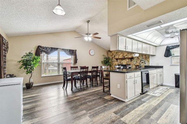 8225 Medford Dr, Port Richey, FL 34668 - kitchen featuring a ceiling fan, dishwashing machine, dark wood-style floors, a sink, and dark countertops