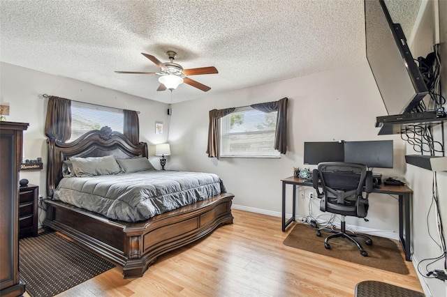 8225 Medford Dr, Port Richey, FL 34668 - bedroom with multiple windows, wood finished floors, a desk, and a textured ceiling