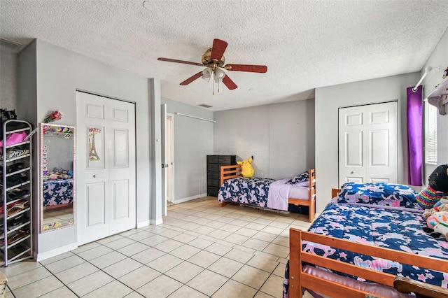 8225 Medford Dr, Port Richey, FL 34668 - bedroom with light tile patterned floors, a textured ceiling, and ceiling fan