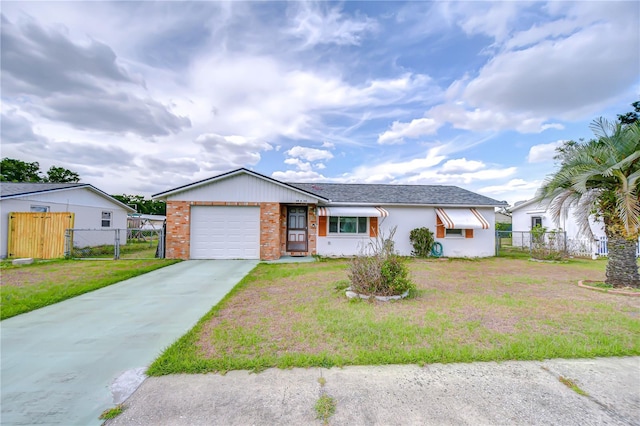 ranch-style house featuring a gate, fence, a front yard, and concrete driveway