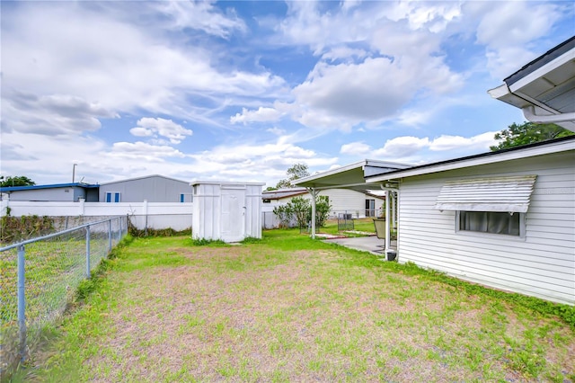 view of yard featuring a fenced backyard, an outbuilding, and a shed