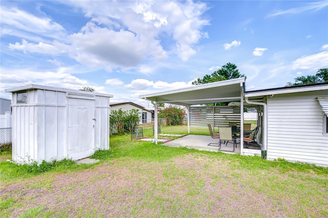 view of yard with fence, a storage unit, an outdoor structure, and a patio area