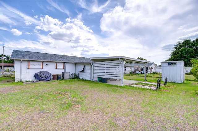 rear view of property featuring a yard and an attached carport