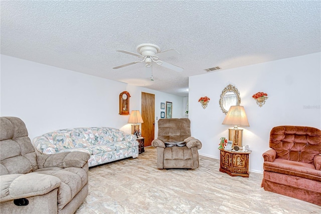 living room featuring a ceiling fan, a textured ceiling, visible vents, and marble finish floor