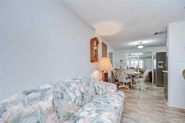 living room featuring a textured ceiling