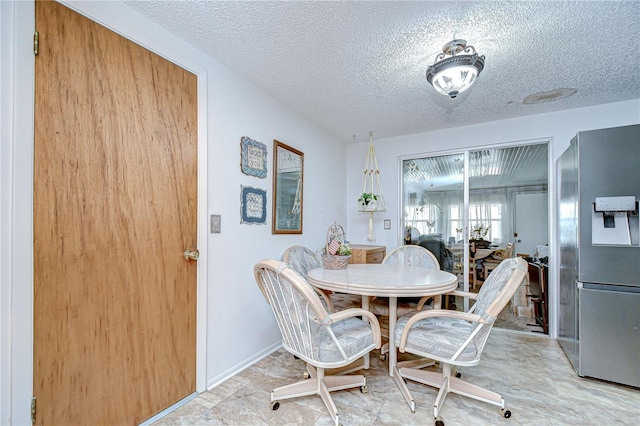 dining room featuring a textured ceiling