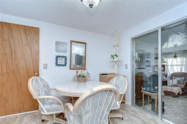 dining space with a textured ceiling
