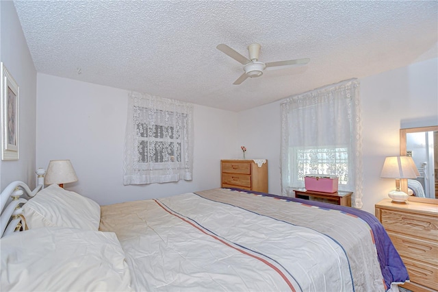 bedroom featuring a ceiling fan and a textured ceiling