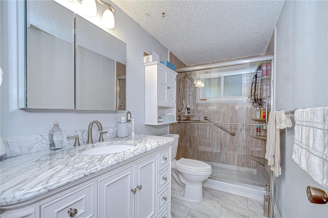 full bath featuring vanity, toilet, a textured ceiling, and a stall shower
