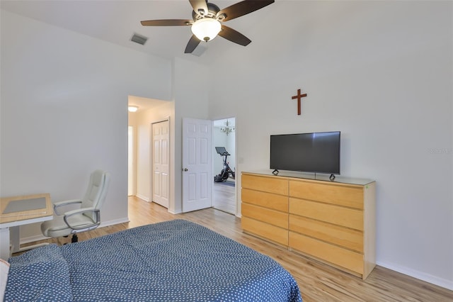 6332 35th Avenue Cir E, Palmetto, FL 34221 - bedroom with light wood-style floors, baseboards, high vaulted ceiling, a ceiling fan, and a closet